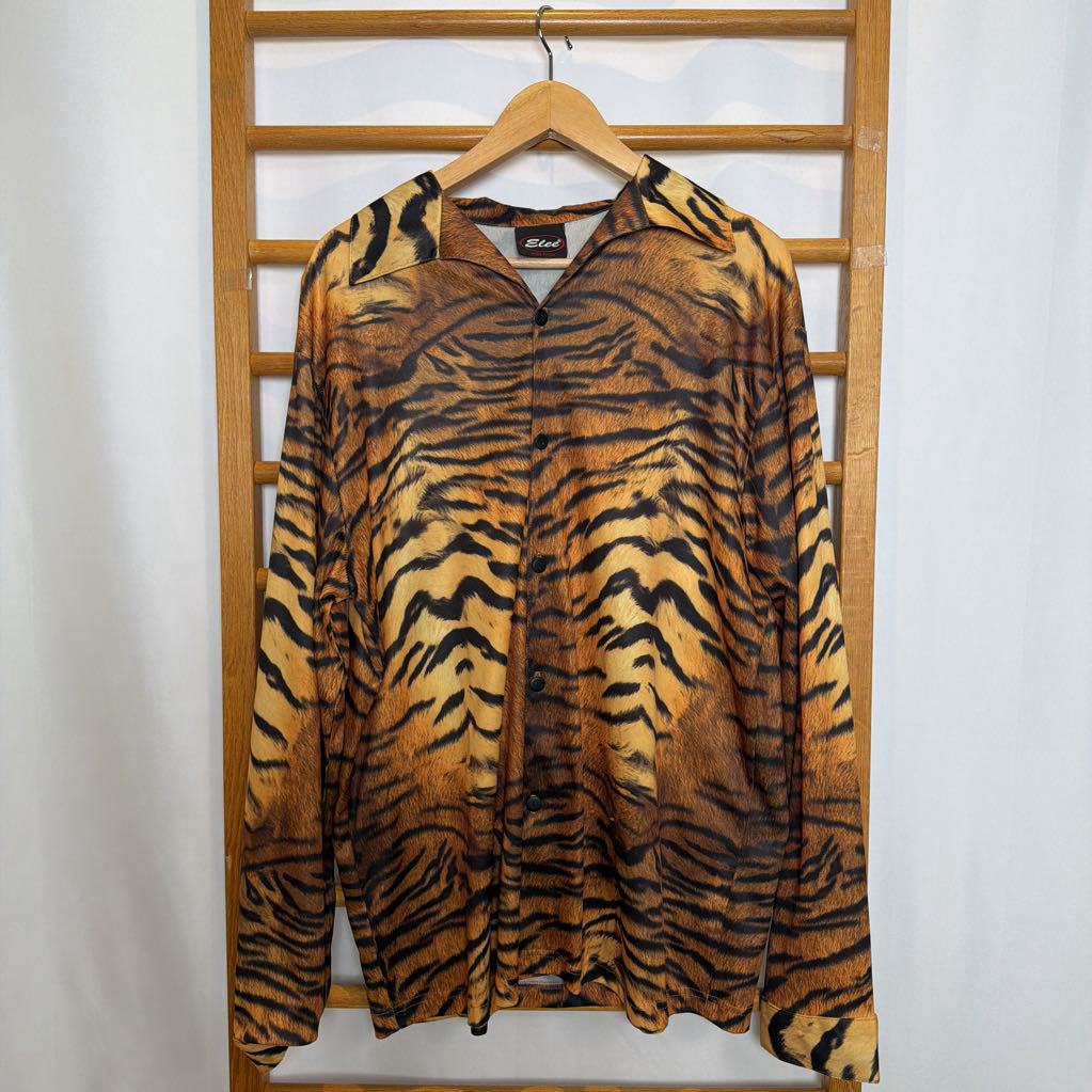 Tiger stripe patterned shirt on a hanger against a wooden lattice background