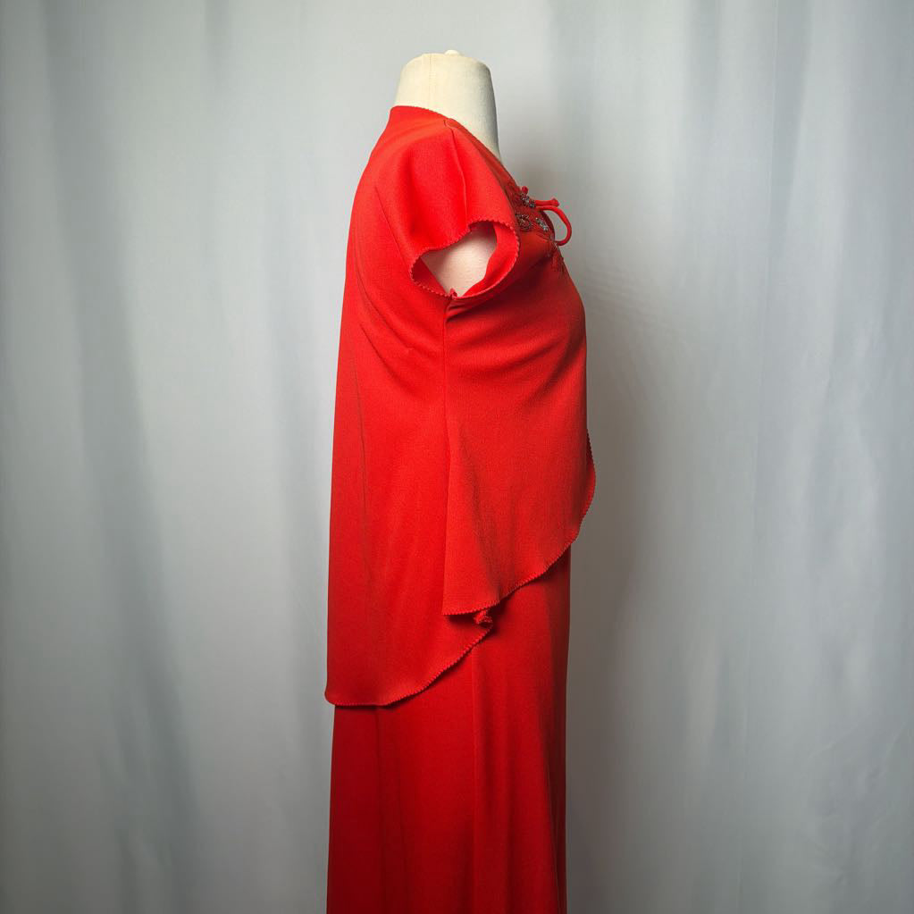 Red dress on a mannequin against a plain background