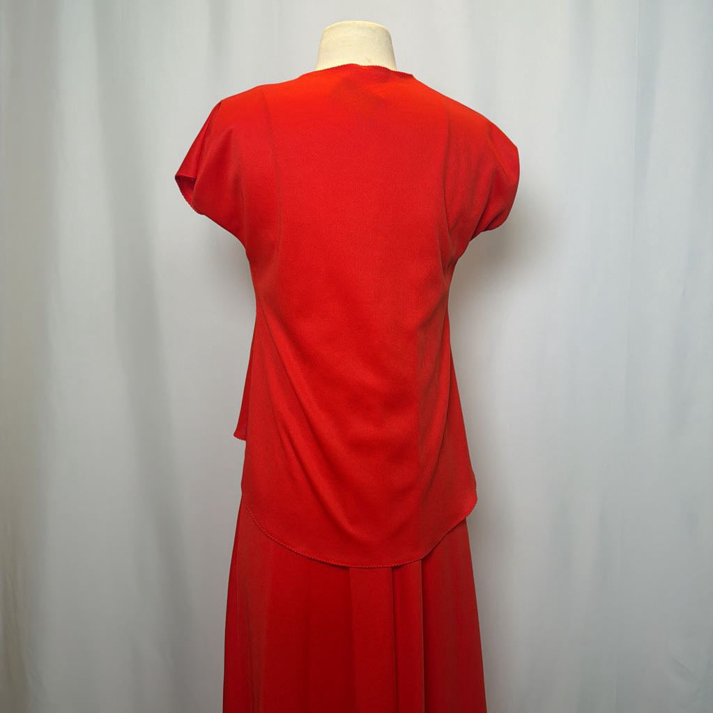 Red dress on a mannequin against a white background