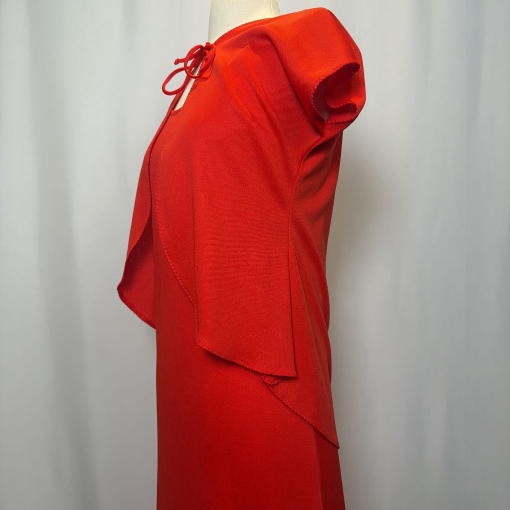 Red dress on a mannequin against a plain background