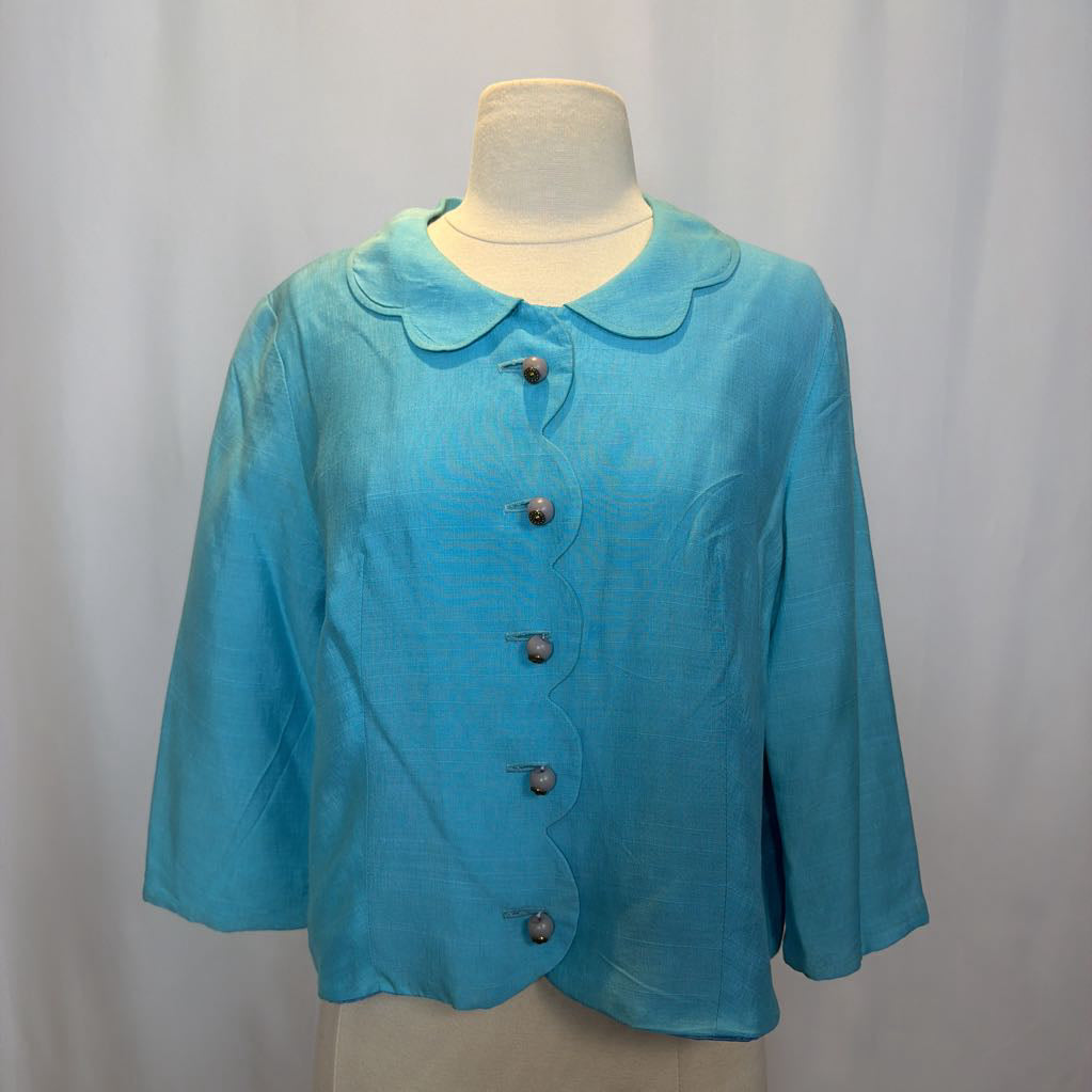 Blue jacket on a mannequin against a plain background