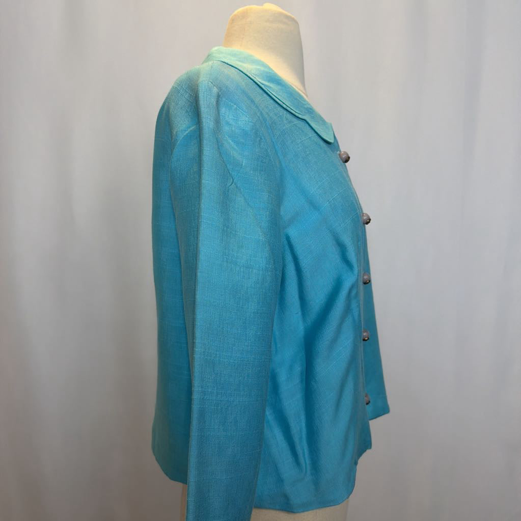 Turquoise jacket on a mannequin against a plain background