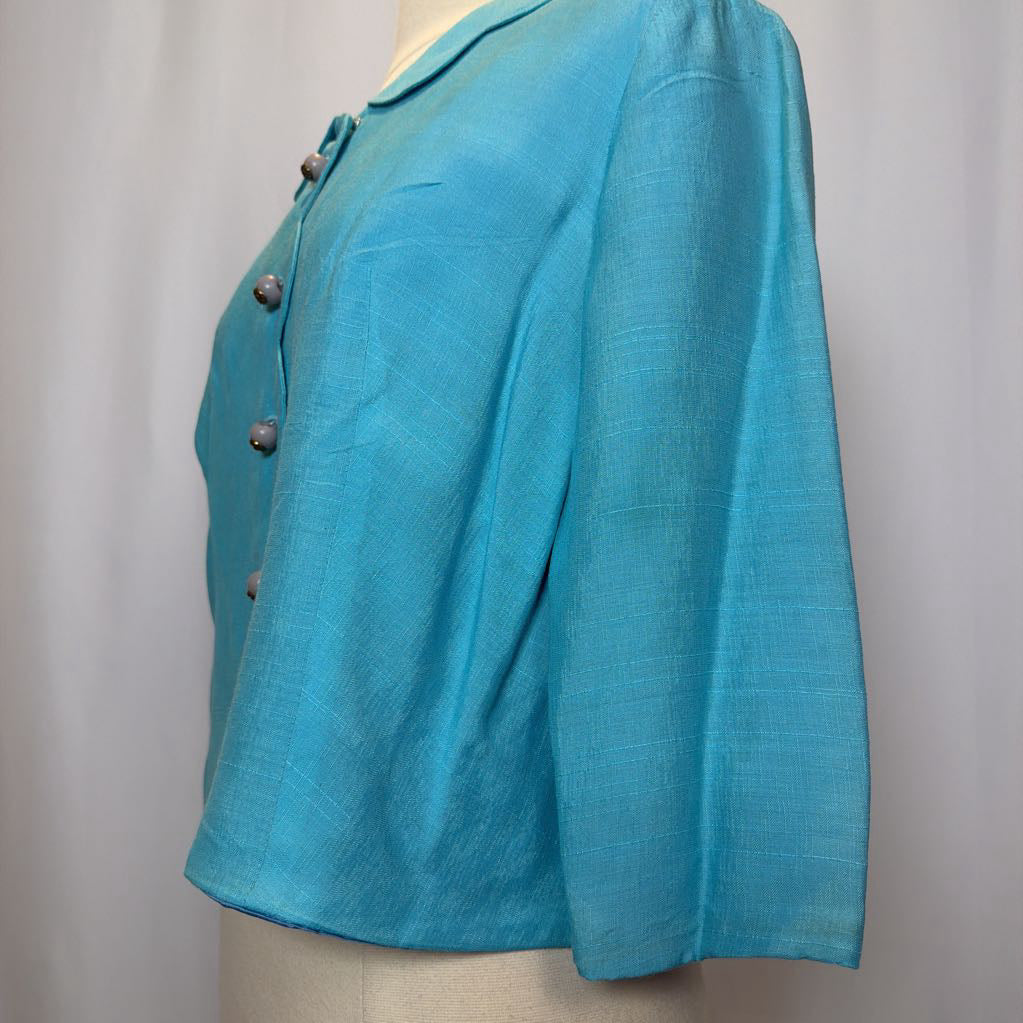 Turquoise blazer on a mannequin against a plain background