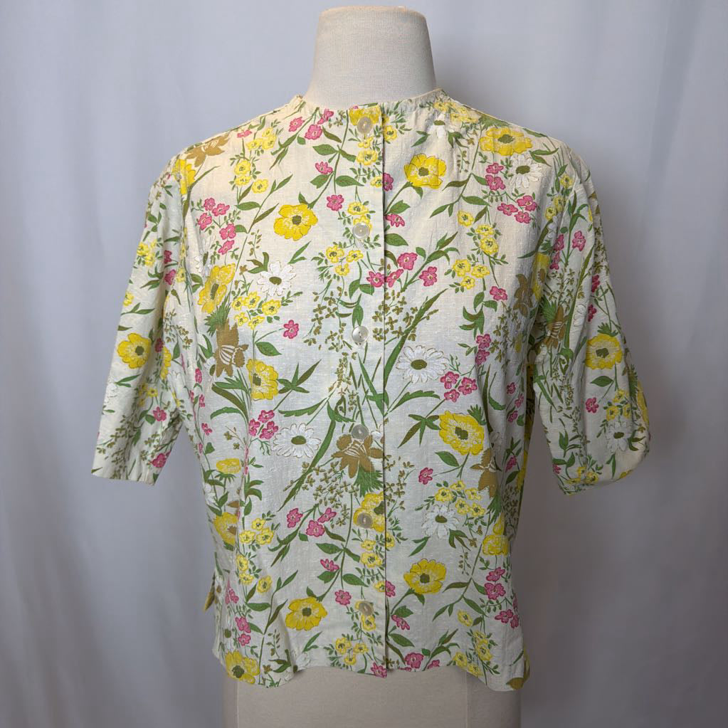 Floral patterned shirt on a mannequin against a plain background