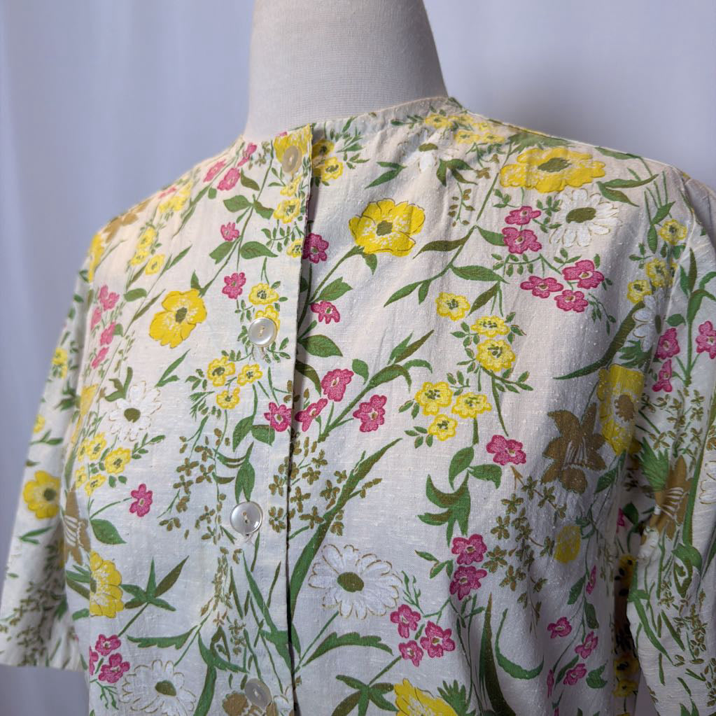 Floral patterned shirt on a mannequin against a plain background