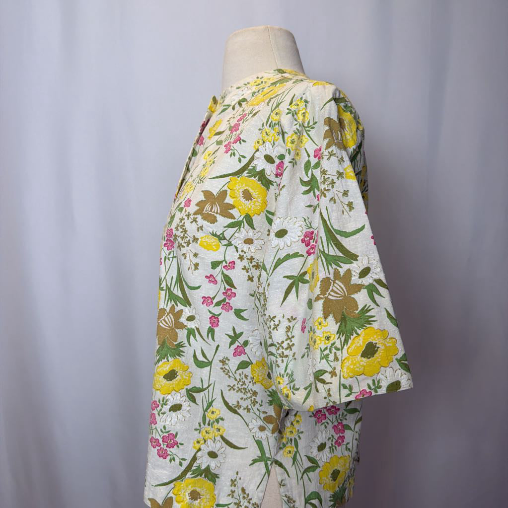 Floral-patterned garment on a mannequin against a plain background
