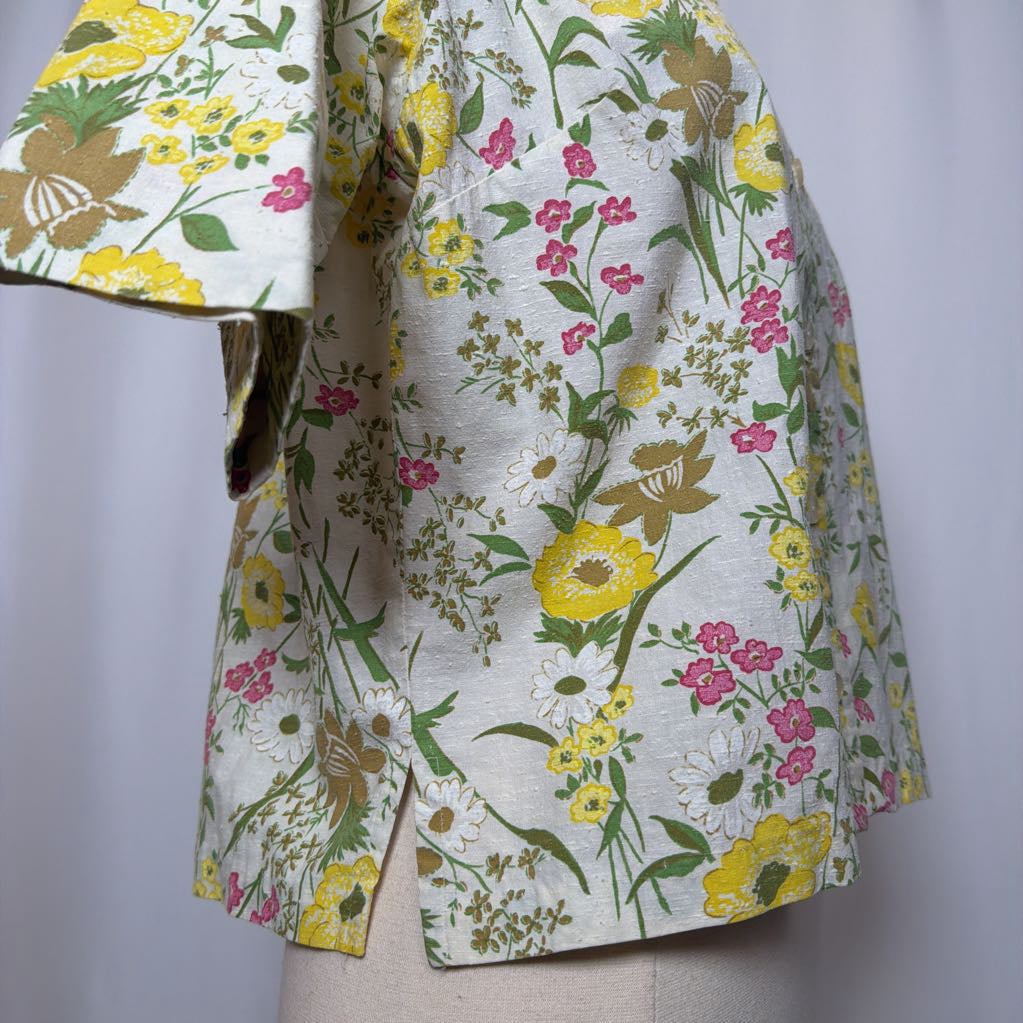 Floral patterned jacket on a mannequin against a plain background
