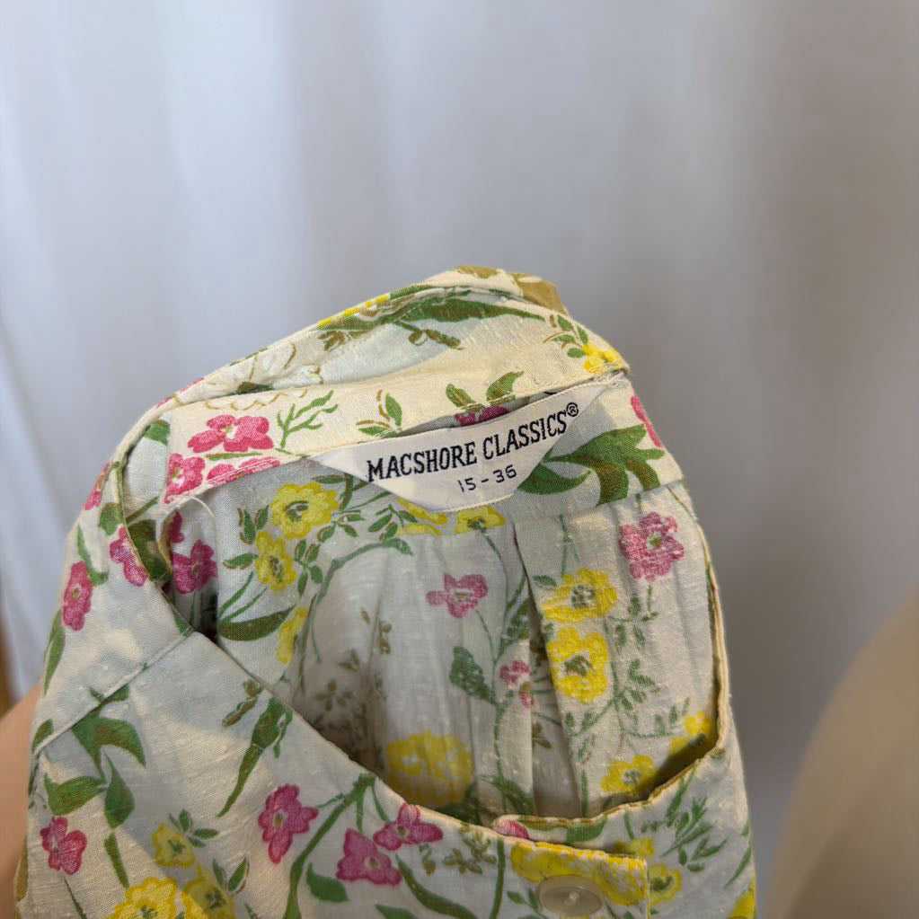 Floral-patterned fabric with a visible brand label on a plain background