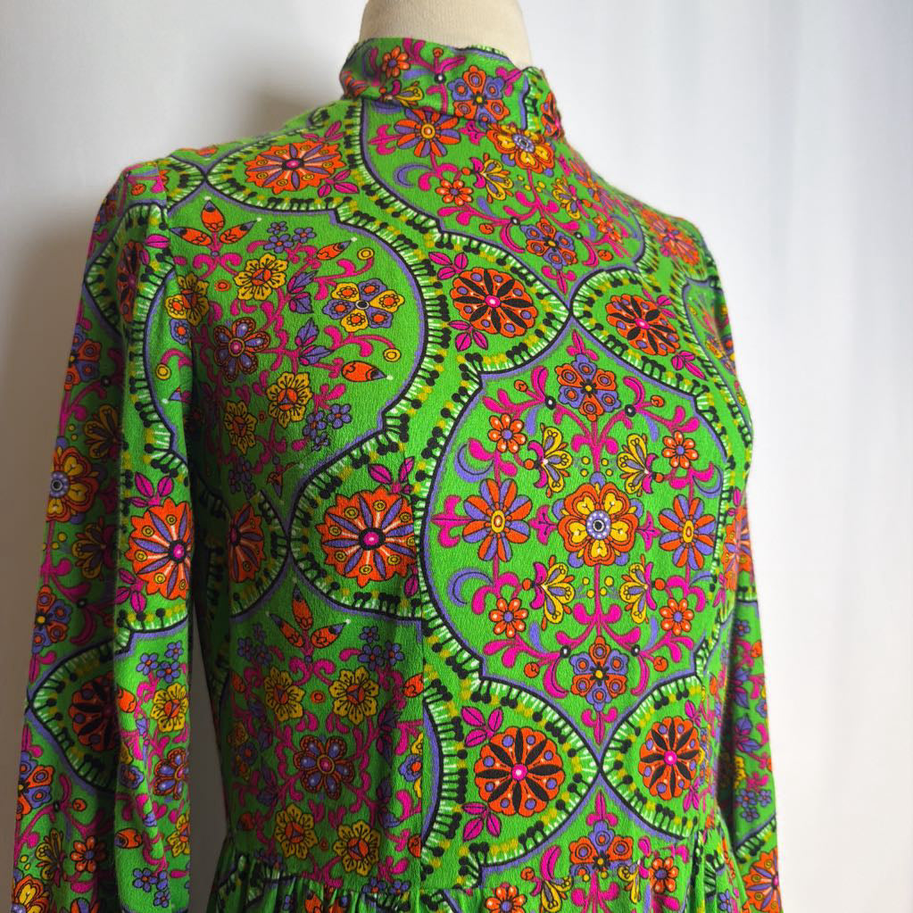 Colorful floral patterned dress on a mannequin against a white background