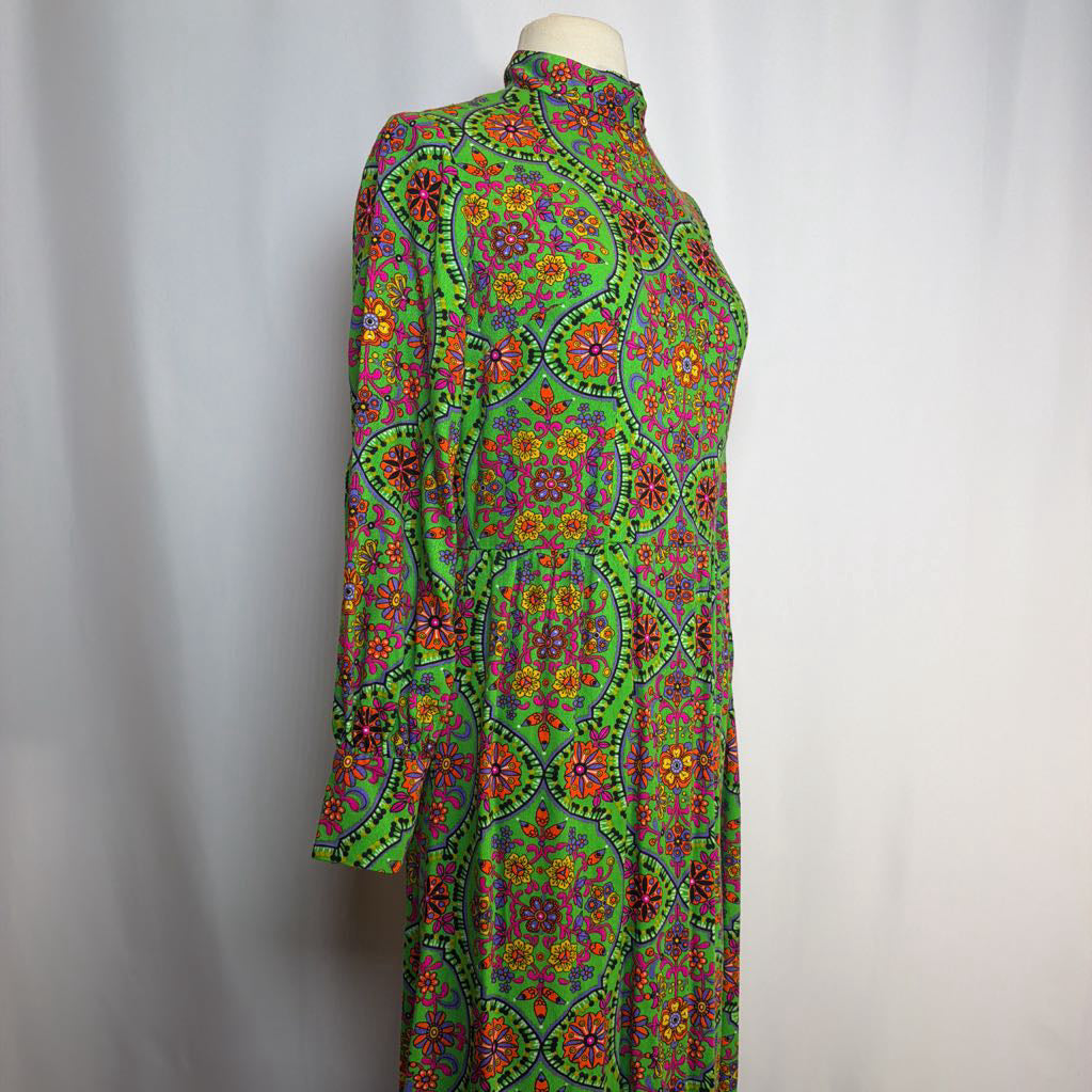 Colorful patterned dress on a mannequin against a plain background