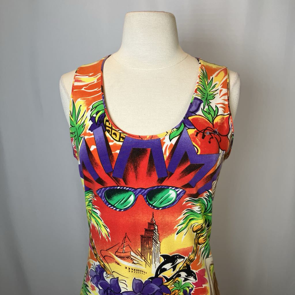 Colorful swimsuit with tropical design on a mannequin against a gray background