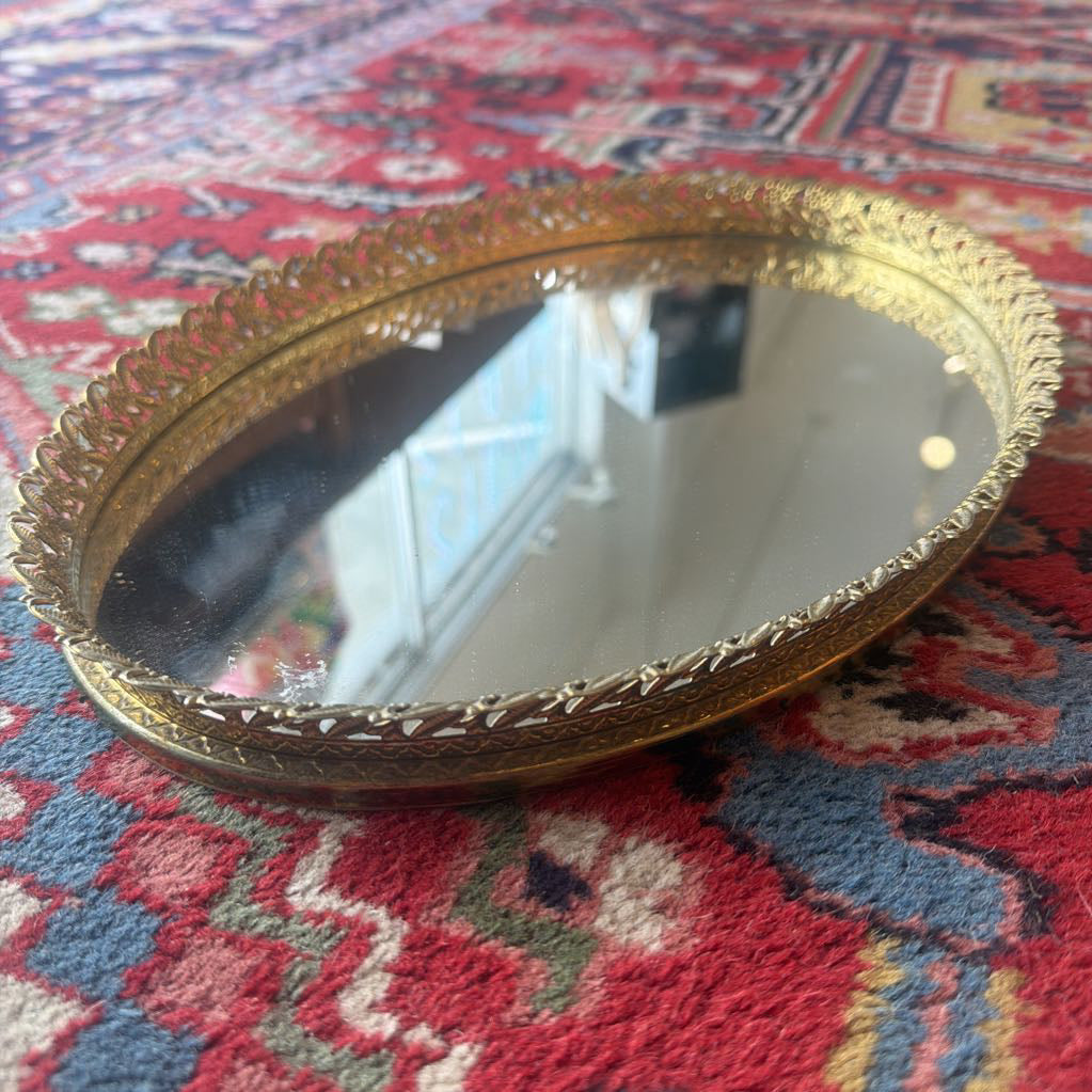 Decorative gold mirror on a patterned rug