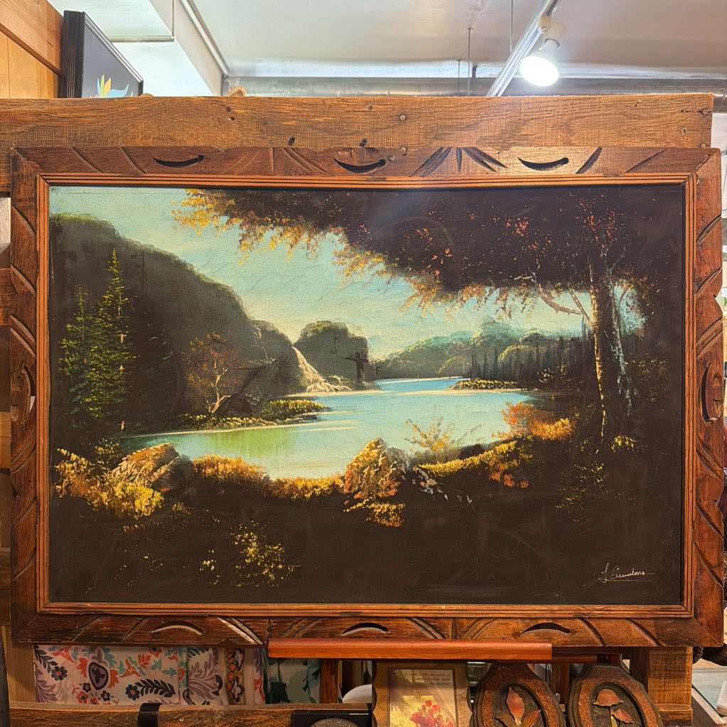 Landscape painting in a wooden frame on an easel