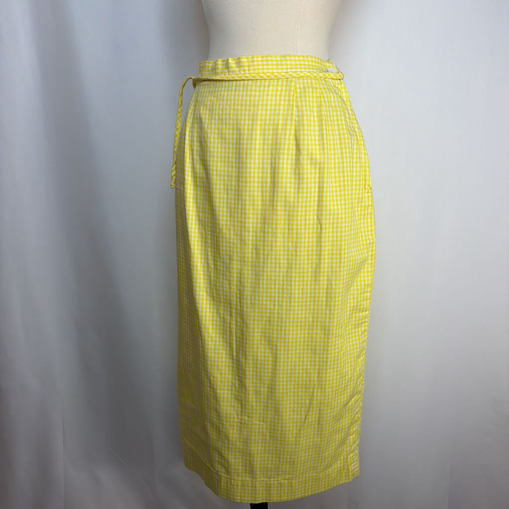 Yellow checkered skirt on a mannequin against a plain background