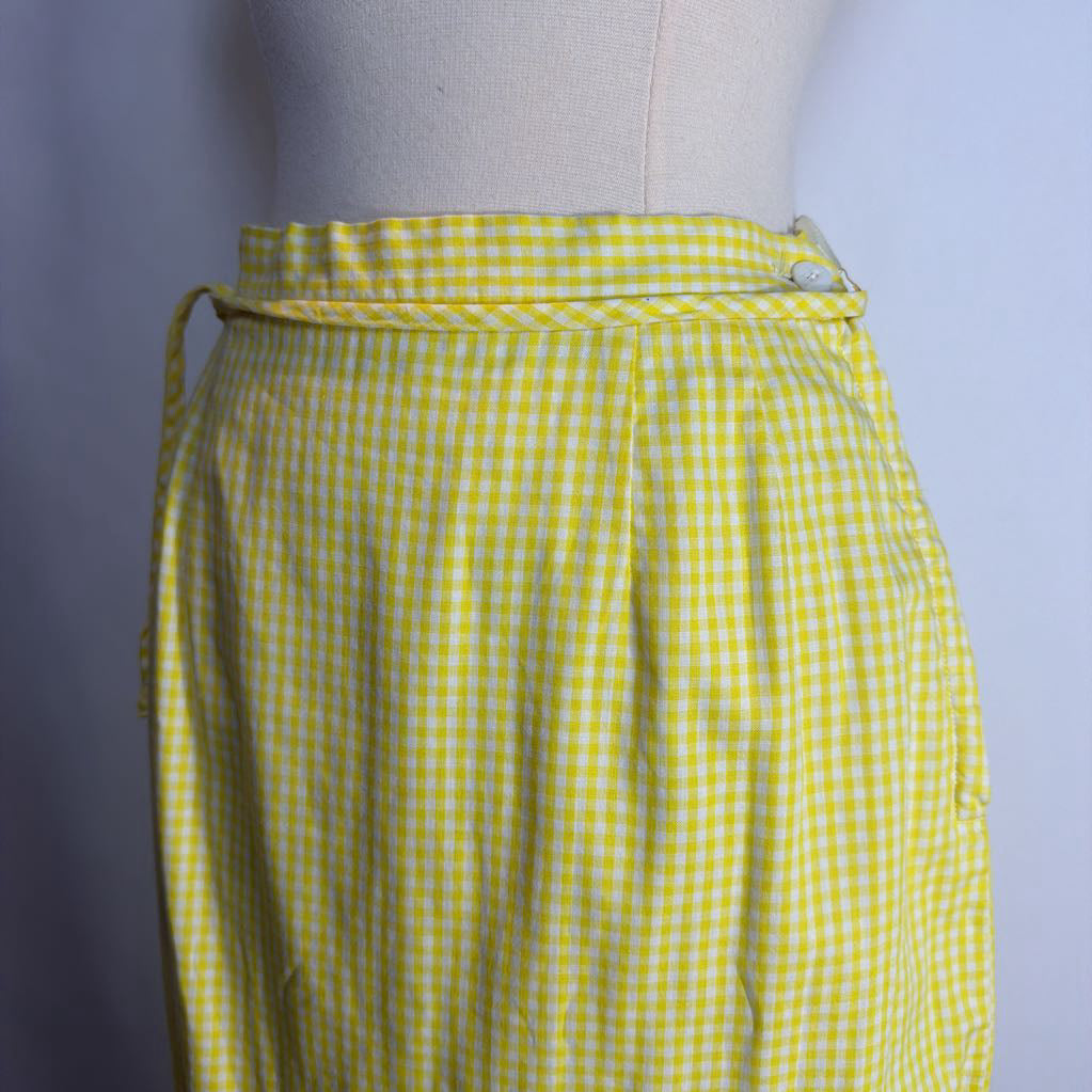 Yellow checkered skirt on a mannequin against a plain background