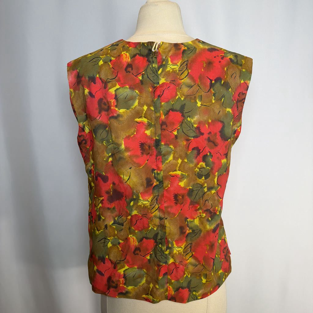 Colorful floral sleeveless top on a mannequin against a plain background
