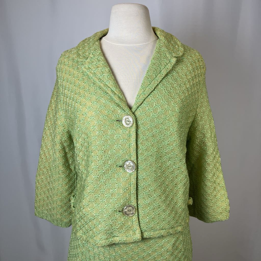 Green textured jacket on a mannequin against a plain background