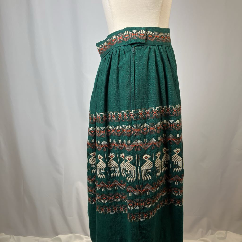 Green skirt with pattern on a mannequin against a plain background