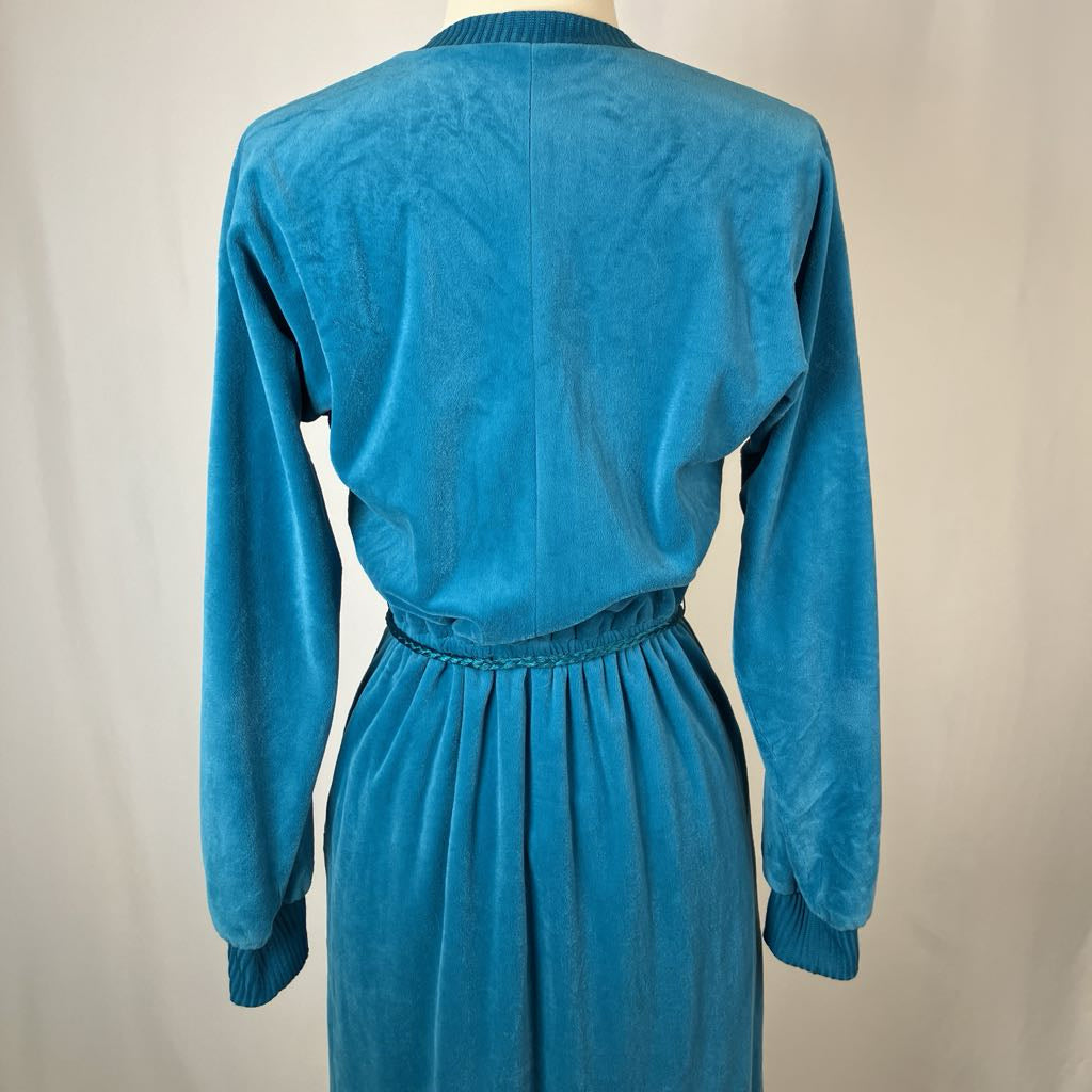 Blue dress on a mannequin against a plain background