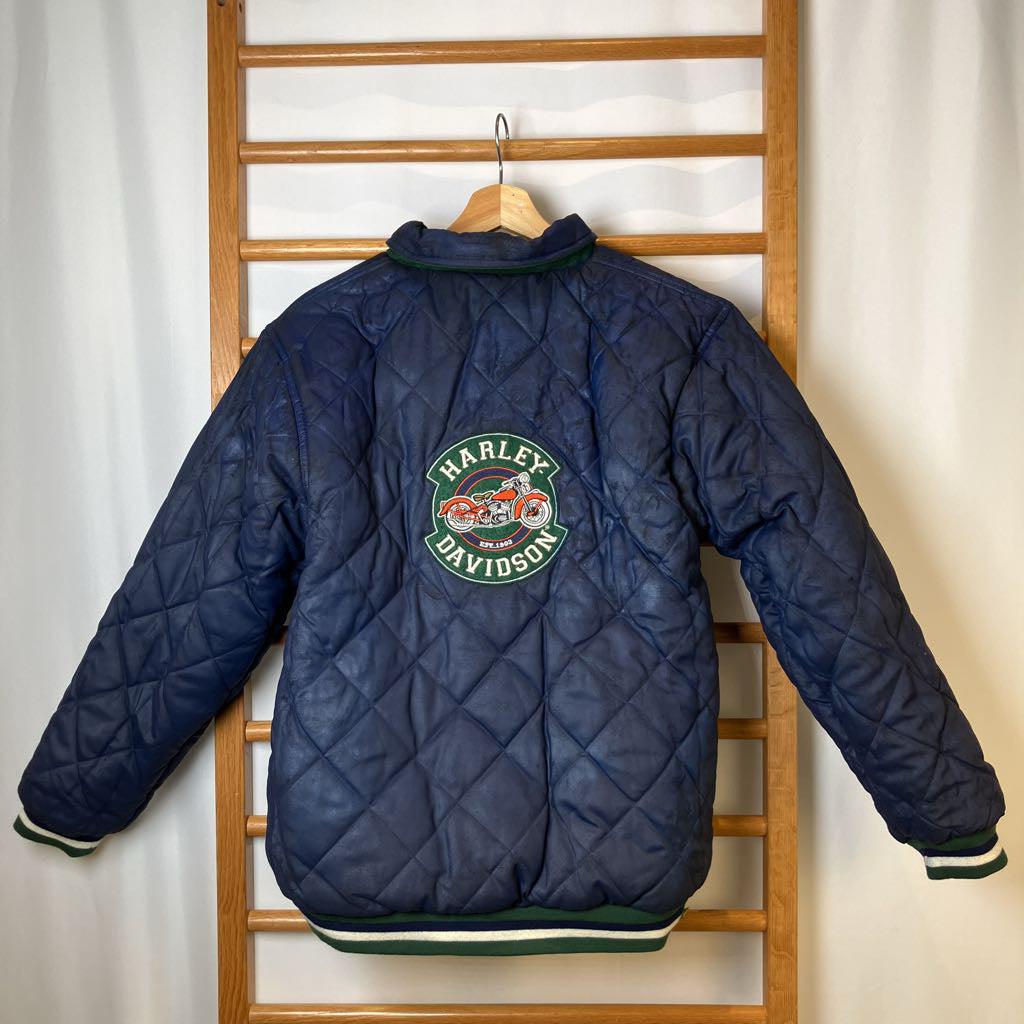 Harley Davidson quilted jacket on a wooden rack against a white curtain background