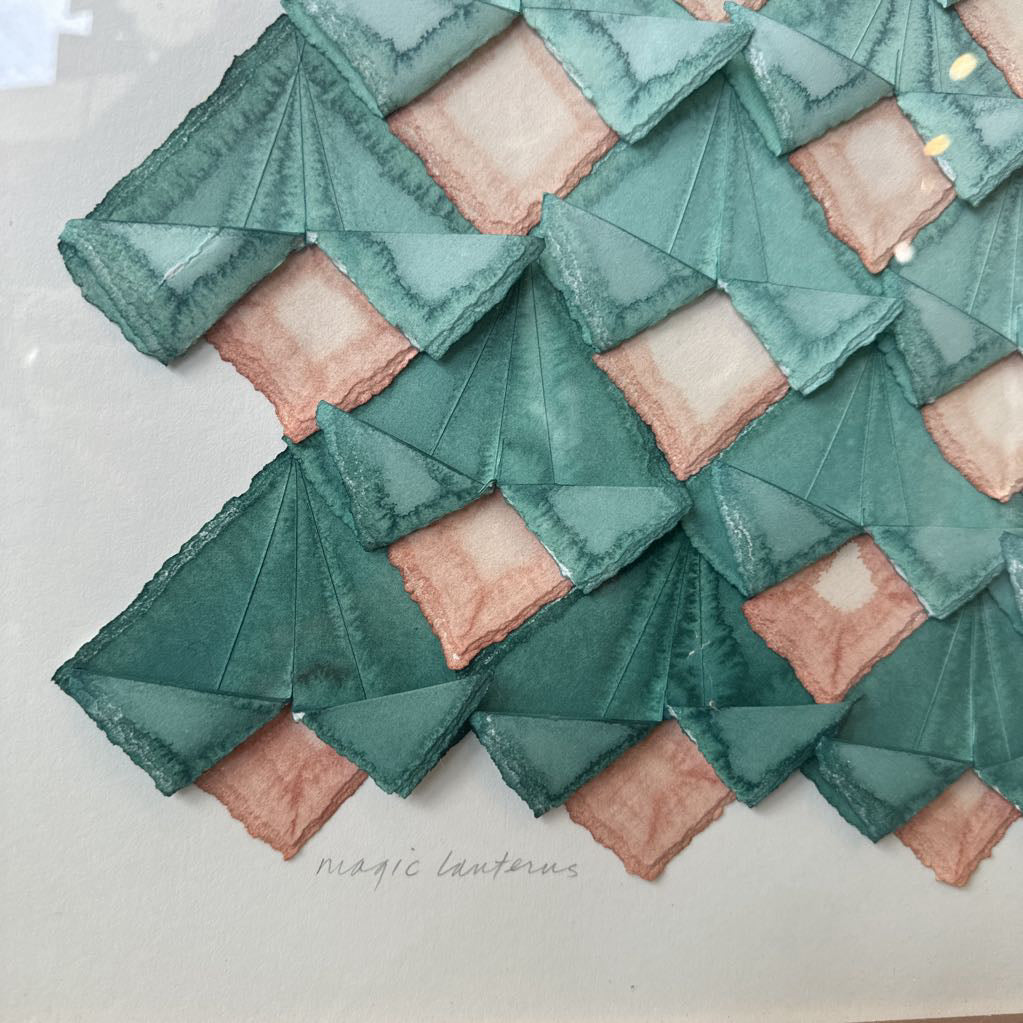 Geometric patterned fabric with green and pink triangles on a white background