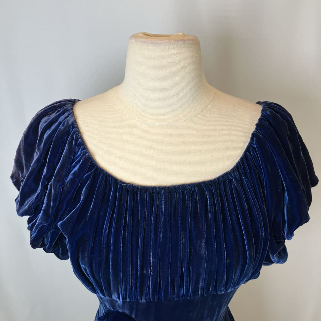Navy blue velvet dress on a mannequin against a plain background