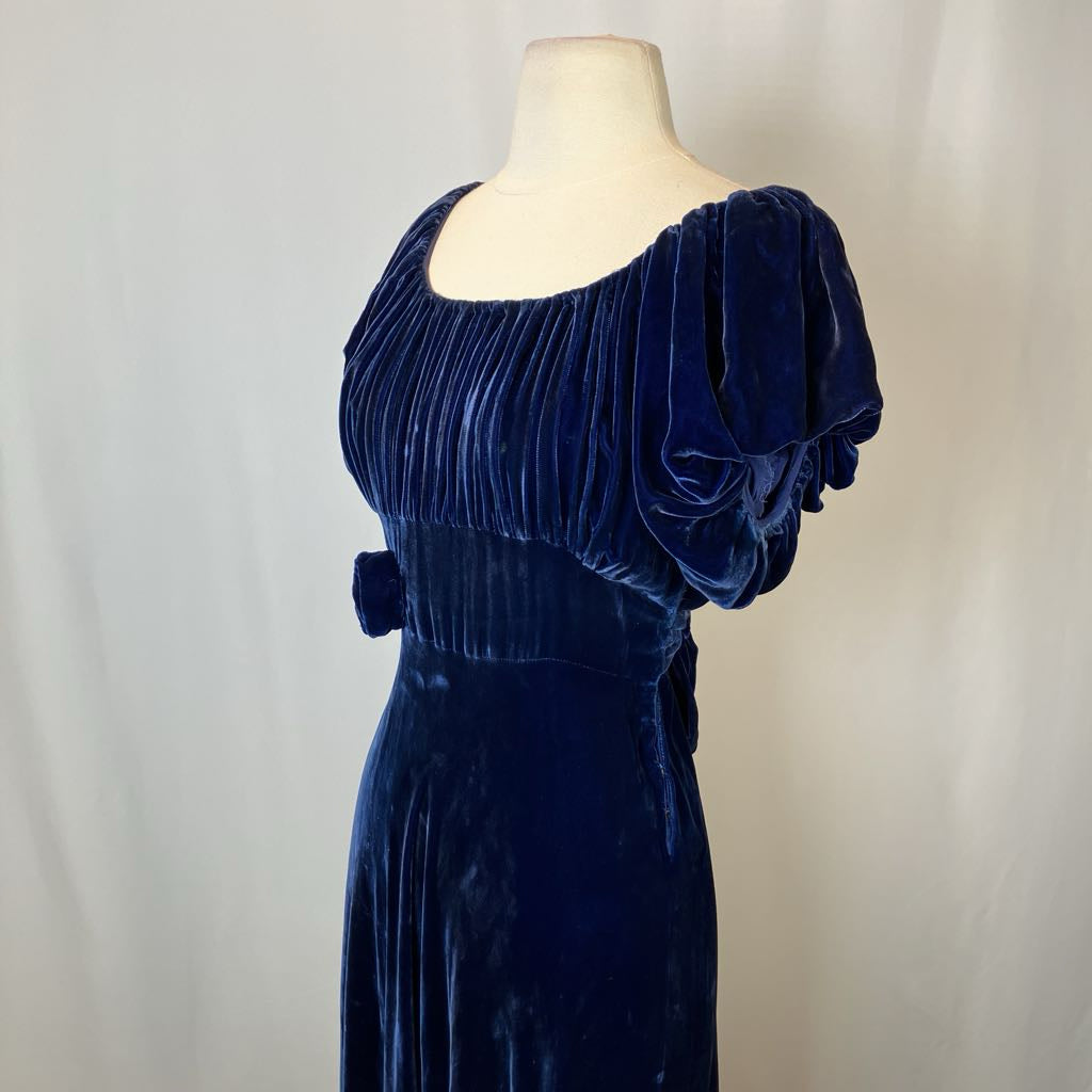 Navy blue velvet dress on a mannequin against a plain background