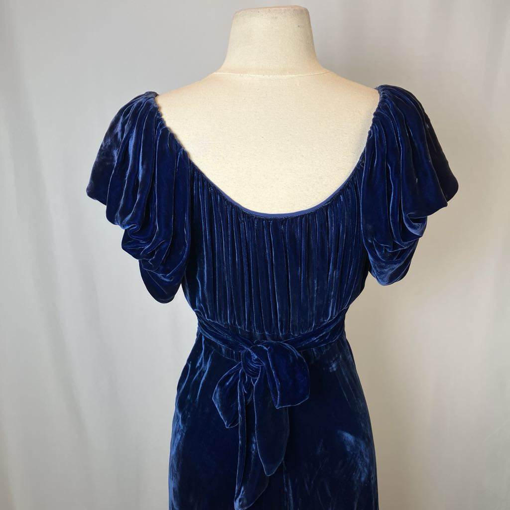 Navy velvet dress on a mannequin against a plain background