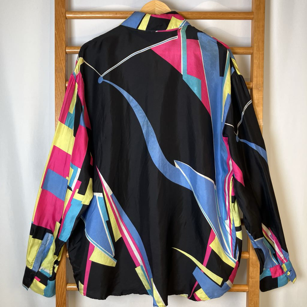 Colorful shirt with geometric pattern on a wooden rack