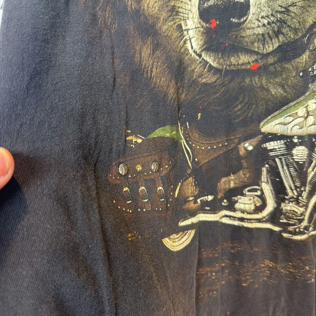 Close-up of a t-shirt with a bear playing a guitar design.