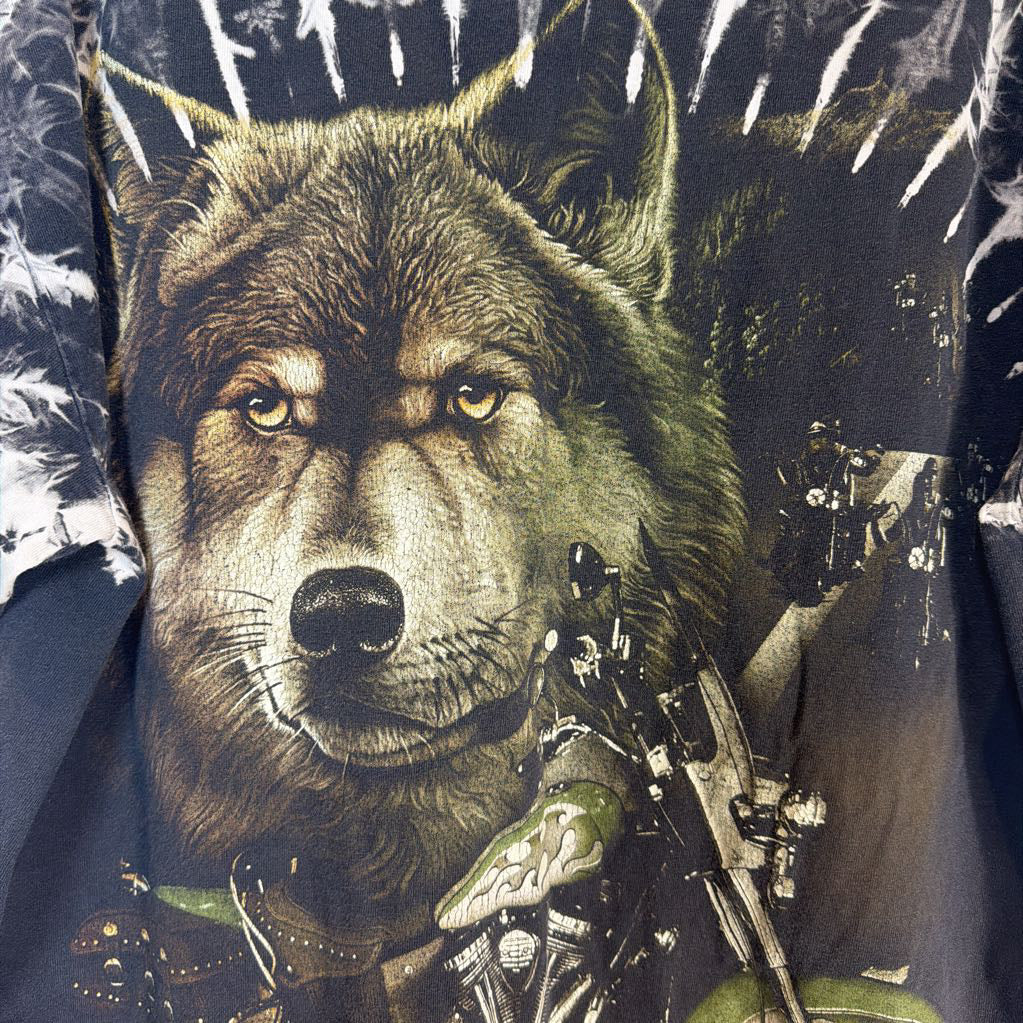 Wolf design on a shirt with a person holding a rifle in the background