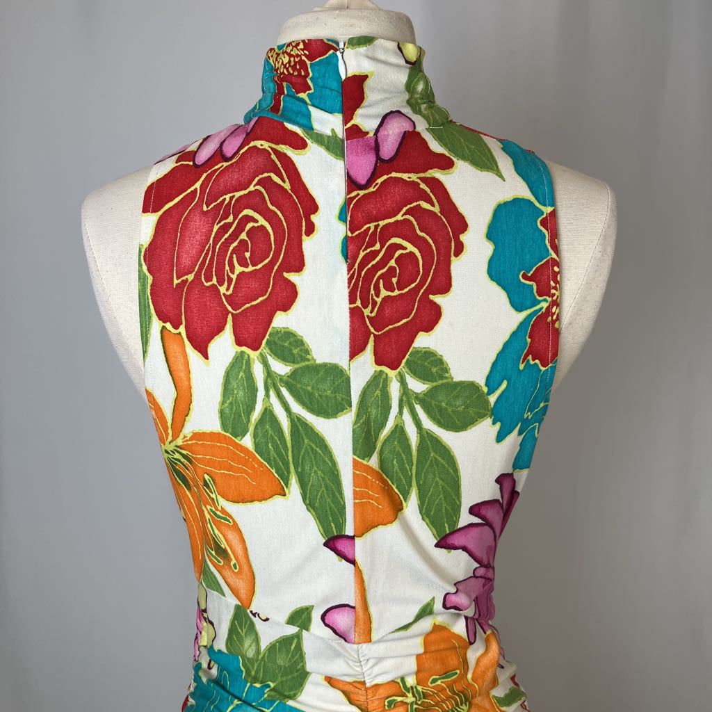 Colorful floral top on a mannequin against a plain background