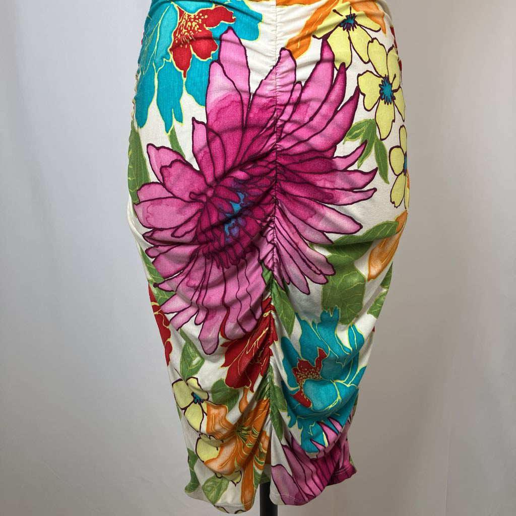 Colorful floral-patterned pants on a mannequin against a plain background