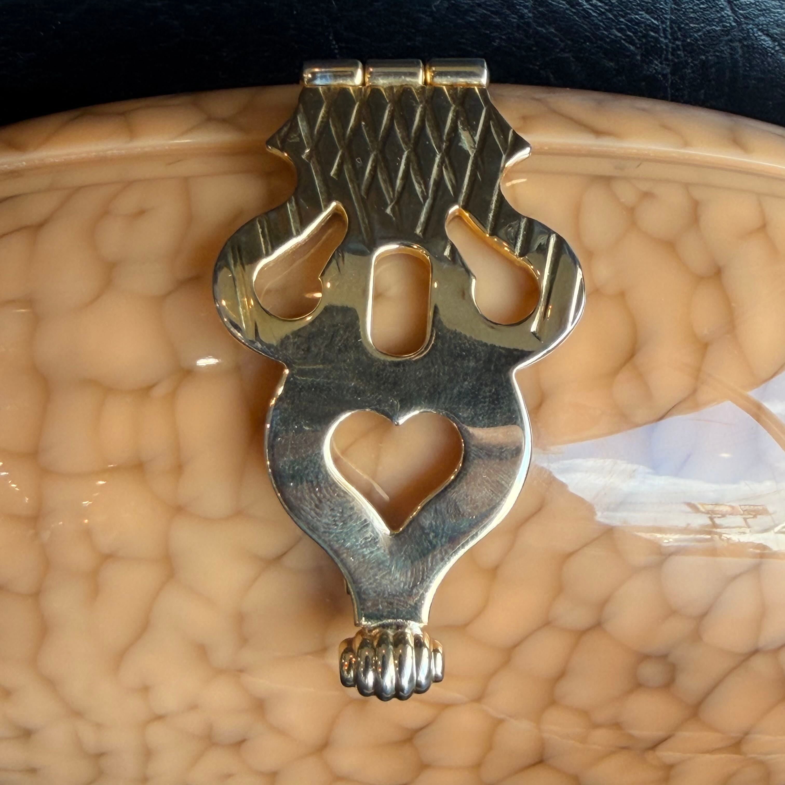 Decorative metal clip on a textured beige surface