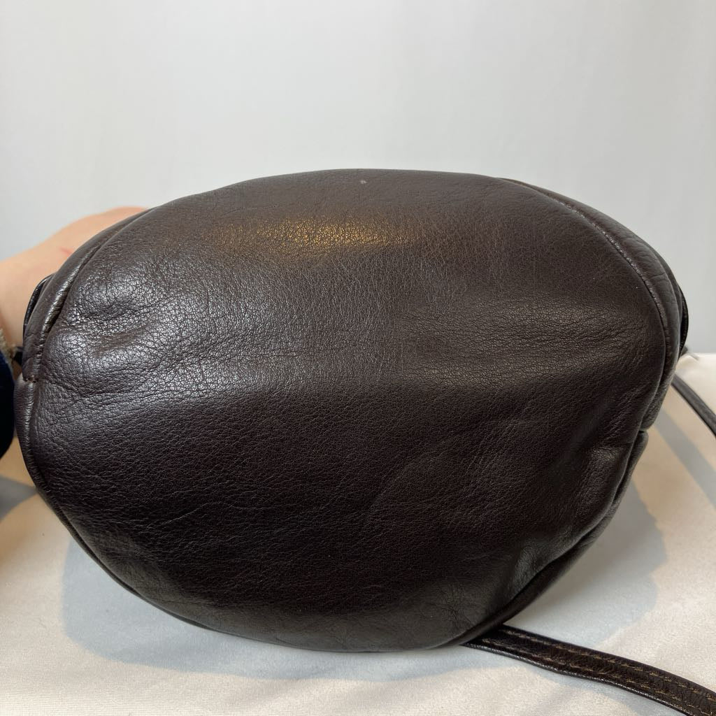 Black leather bag on a light gray background