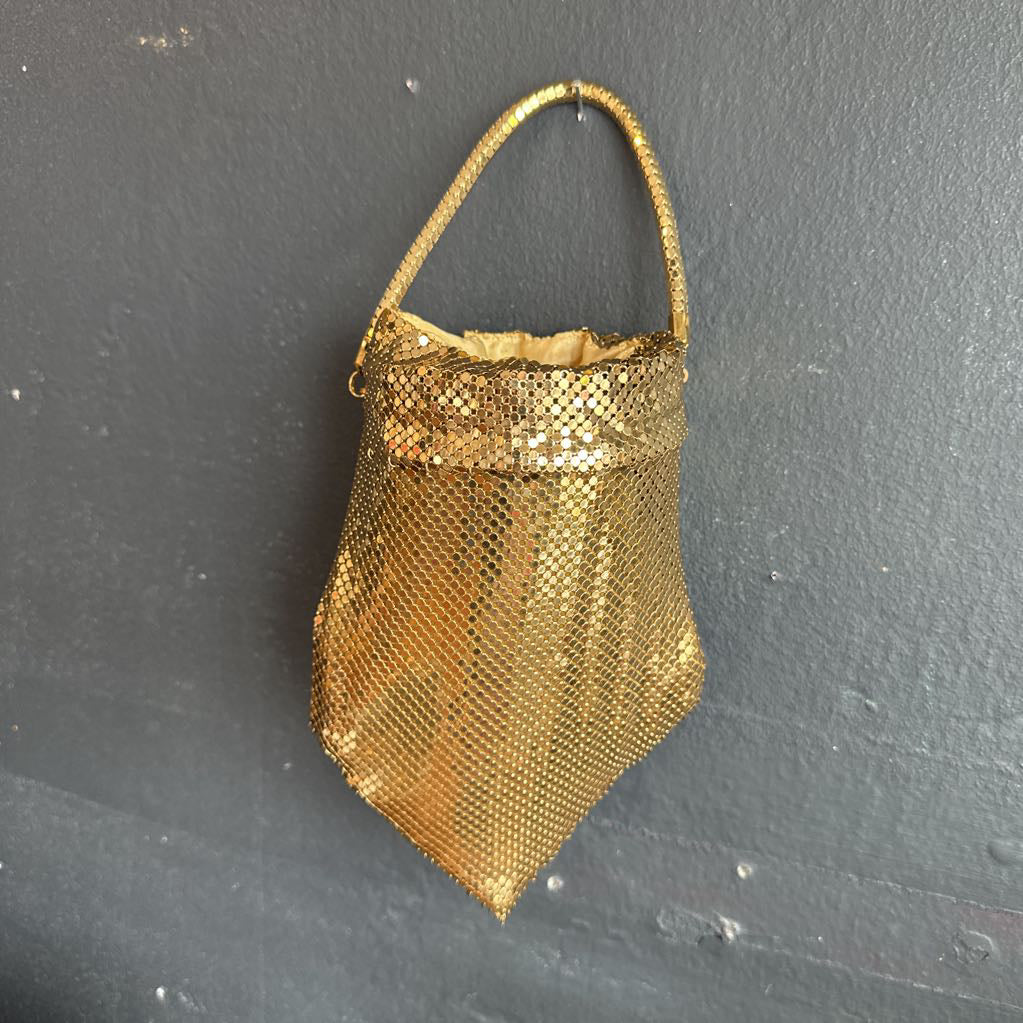 Gold mesh bag on a dark gray background