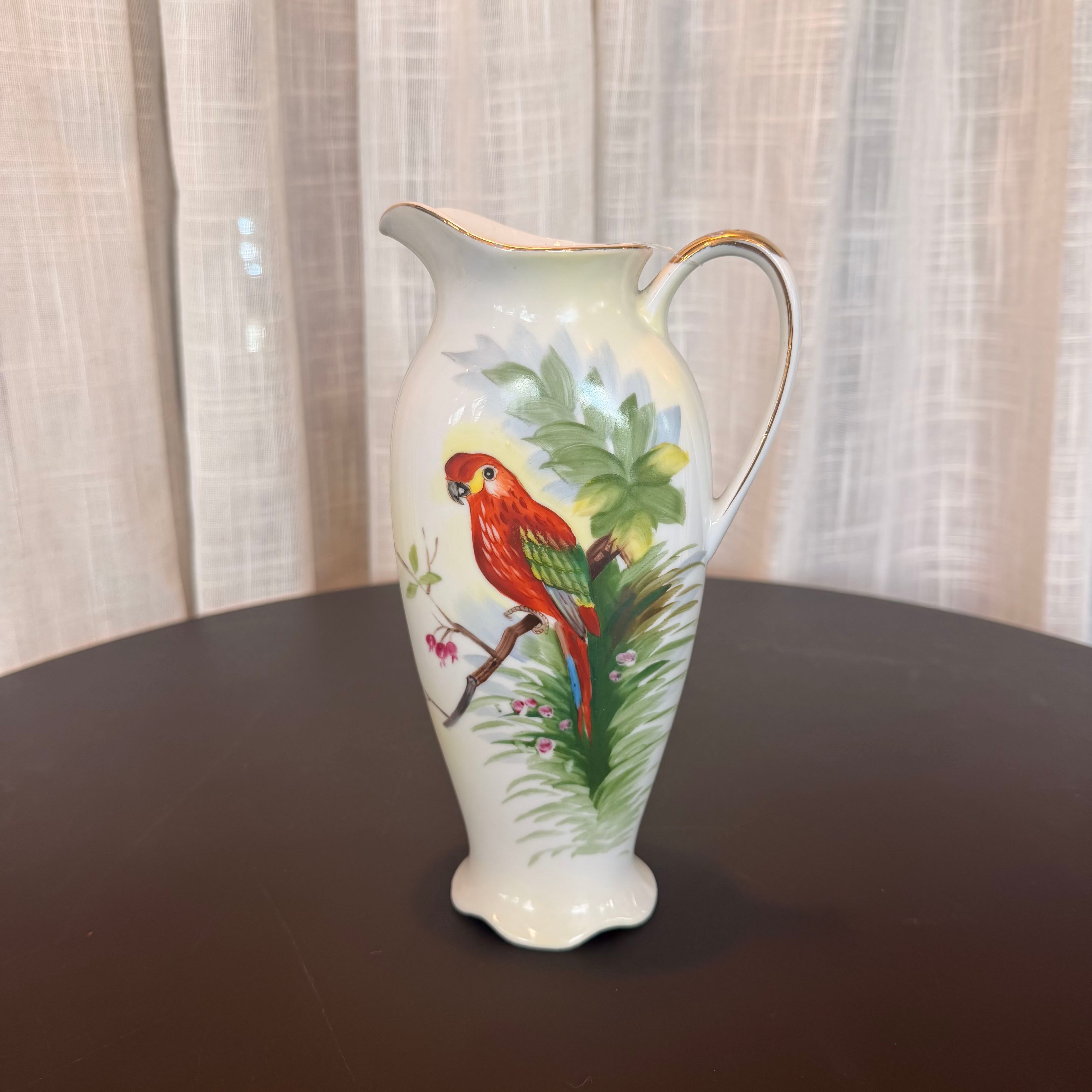 Decorative vase with a parrot design on a dark surface