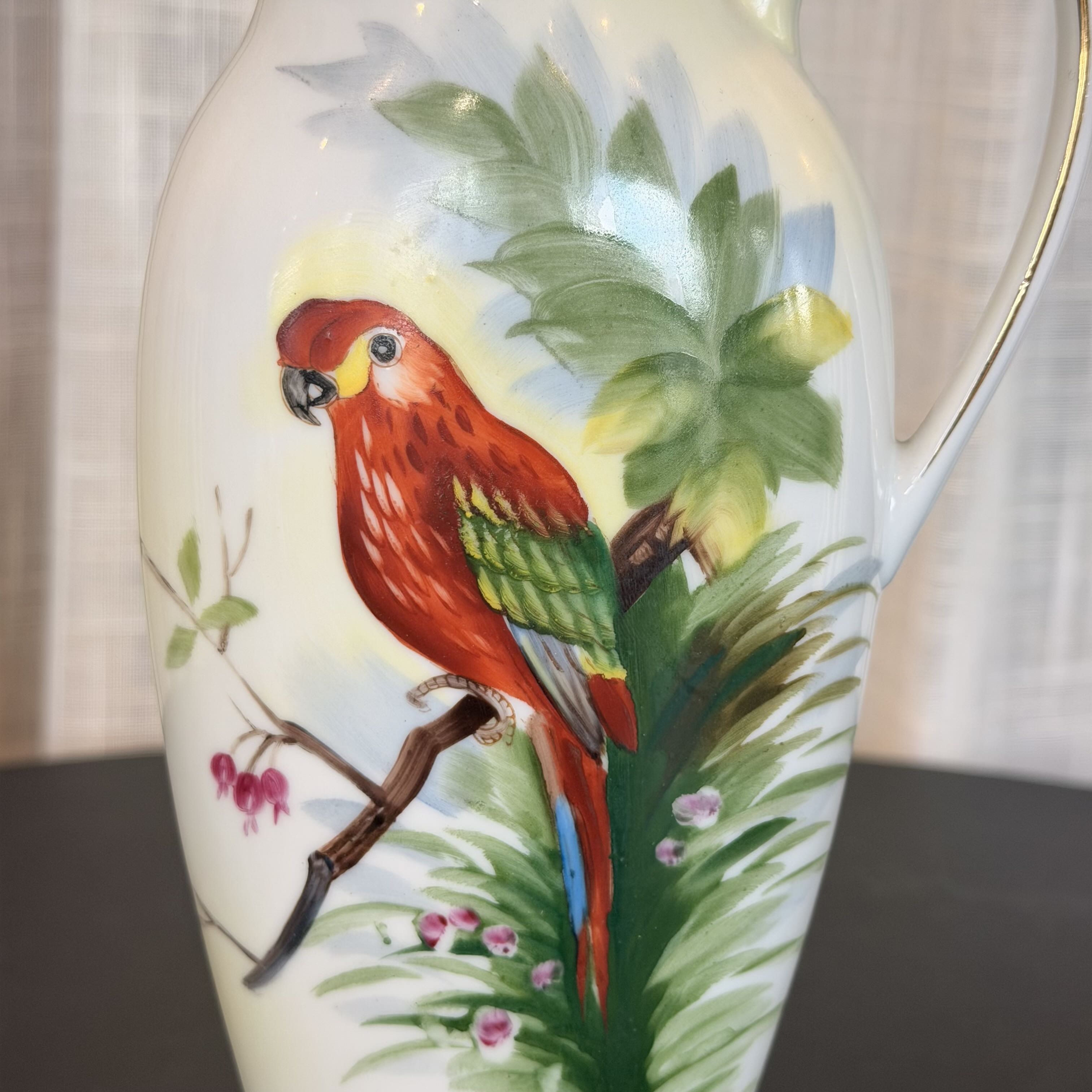Vase with a parrot and tropical leaf design on a white background