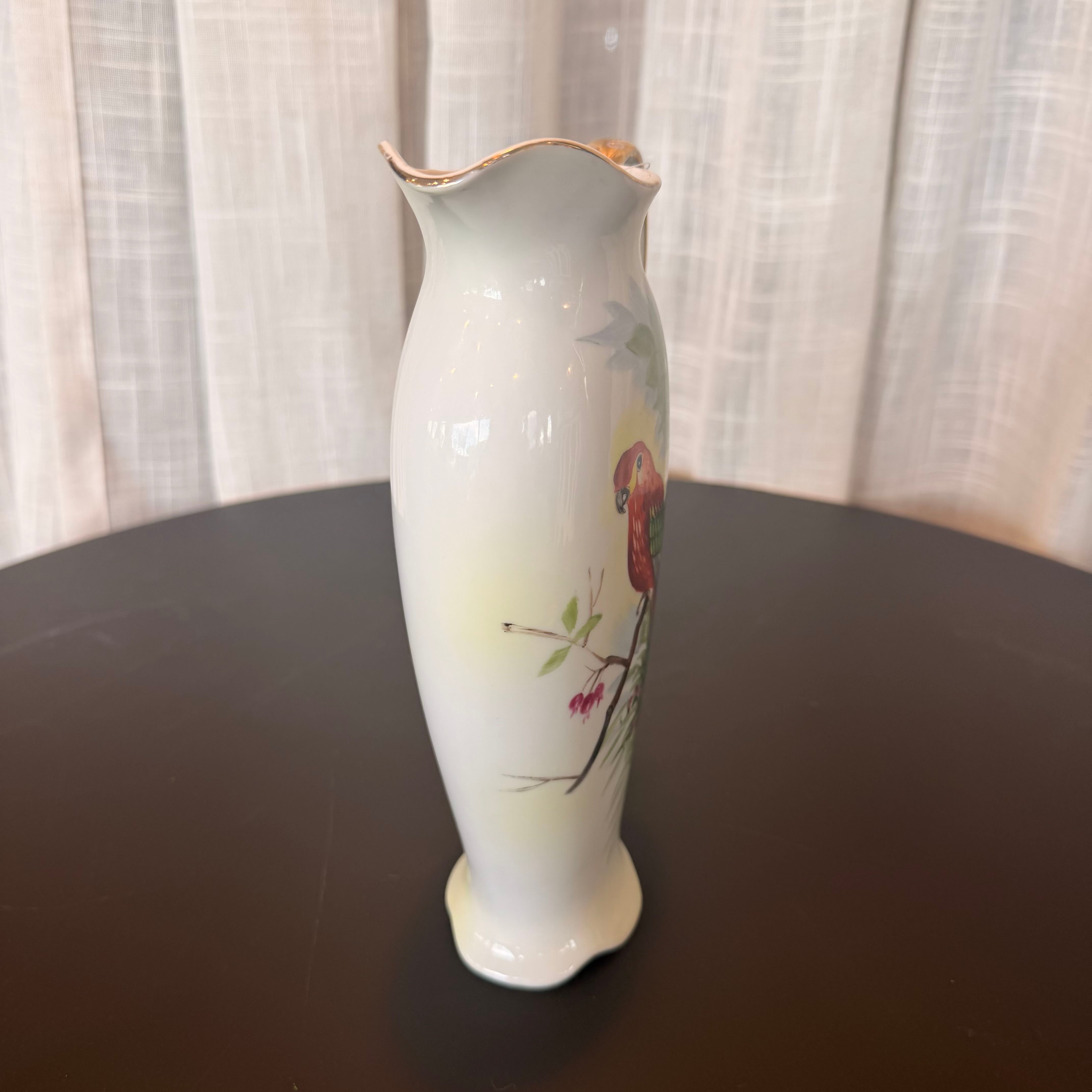 White vase with floral design on a dark surface with a light curtain background