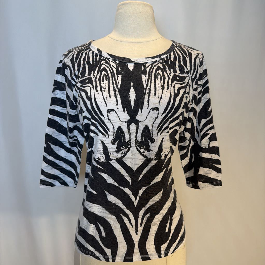 Zebra patterned top on a mannequin against a neutral background
