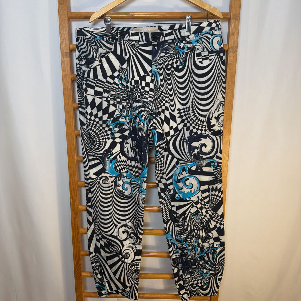 Black and white patterned pants with blue accents on a wooden hanger against a white background