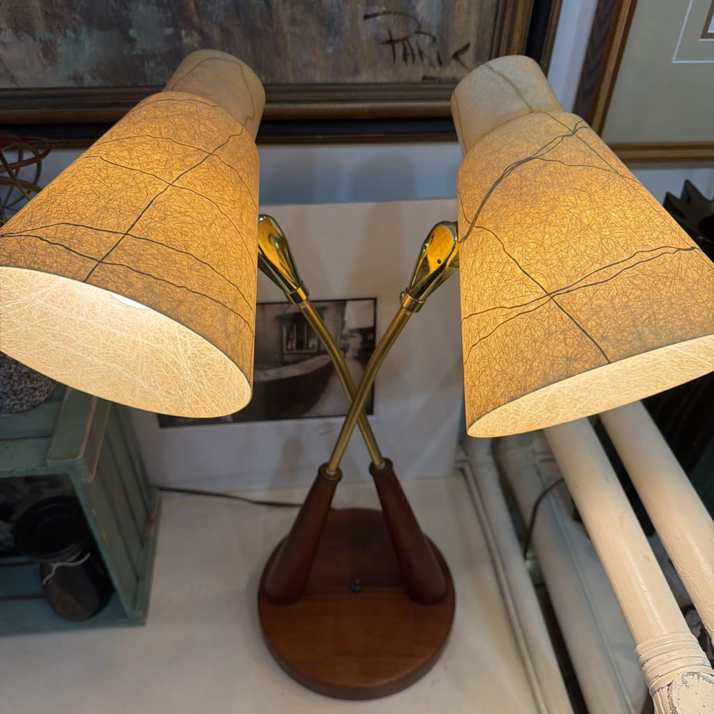 Pair of table lamps with wooden bases and fabric shades in a room setting.