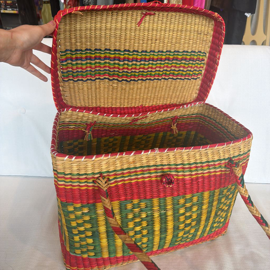 Woven basket with colorful patterns on a white background