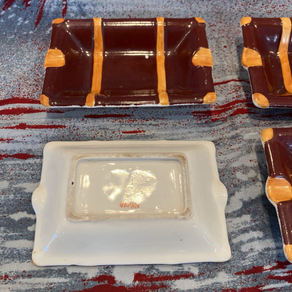 Rectangular ceramic dish with gold accents on a textured surface