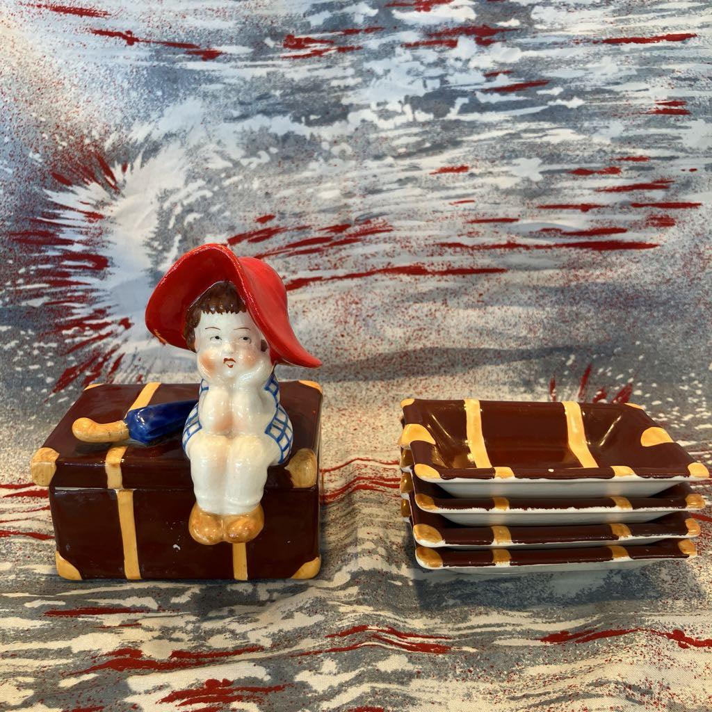 Small figurine with a red hat on a decorative surface