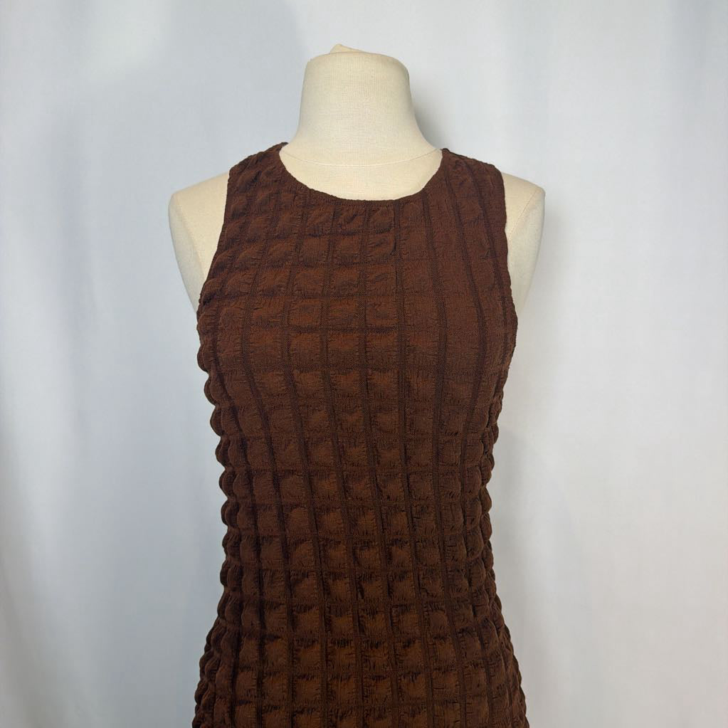 Brown textured dress on a mannequin against a plain background