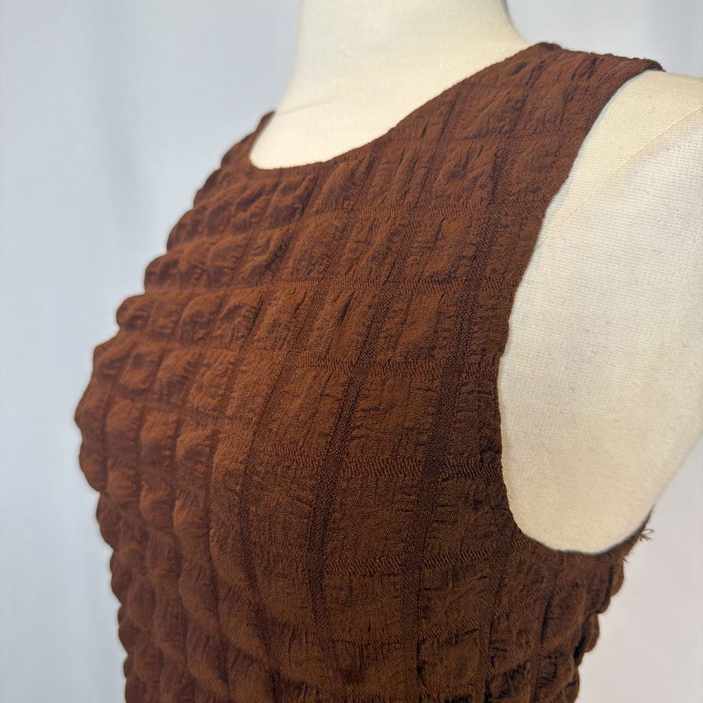 Brown textured vest on a mannequin against a light gray background