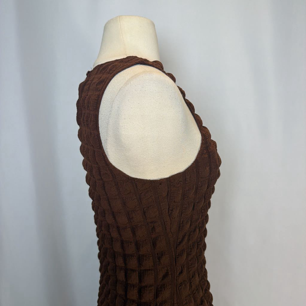 Brown knitted sleeveless top on a mannequin against a white background