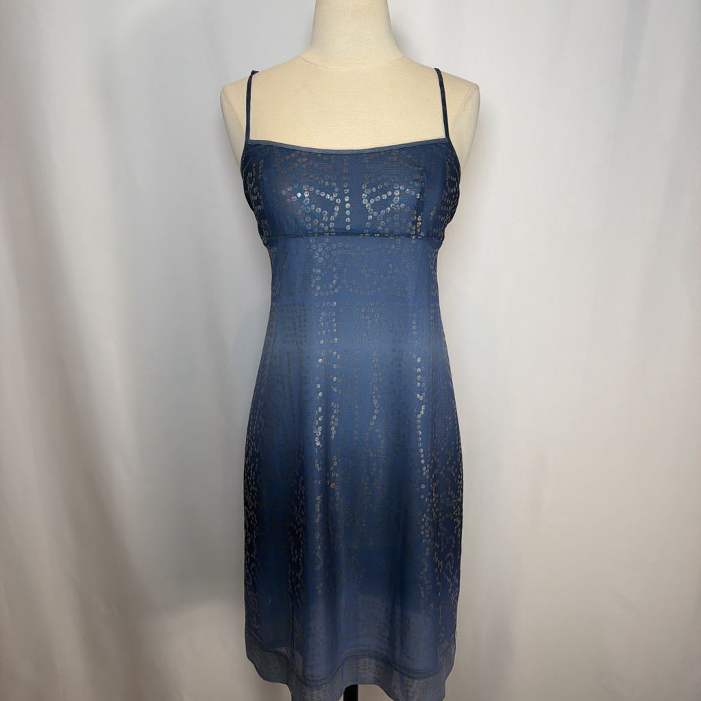 Blue dress on a mannequin against a plain background