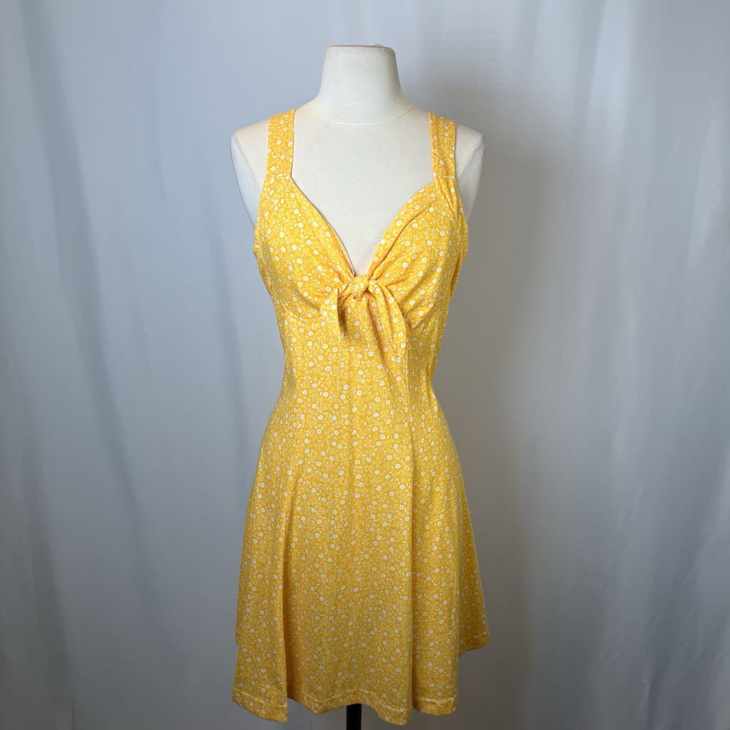 Yellow polka dot and floral dress on a mannequin against a white background